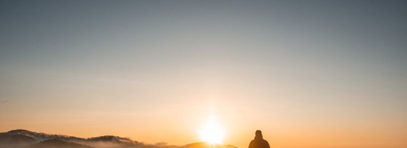 silhouette of person standing near camping tent